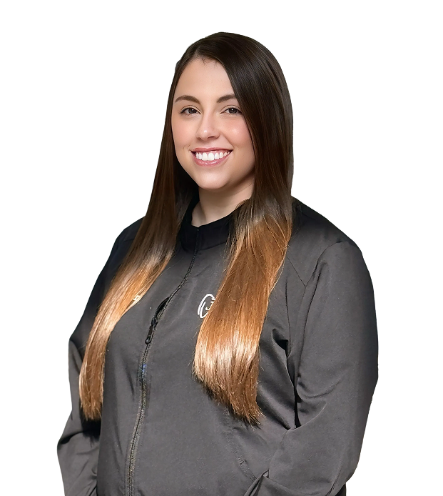 Smiling woman with long, straight hair in a black jacket stands against a black background. Her posture is relaxed and welcoming.