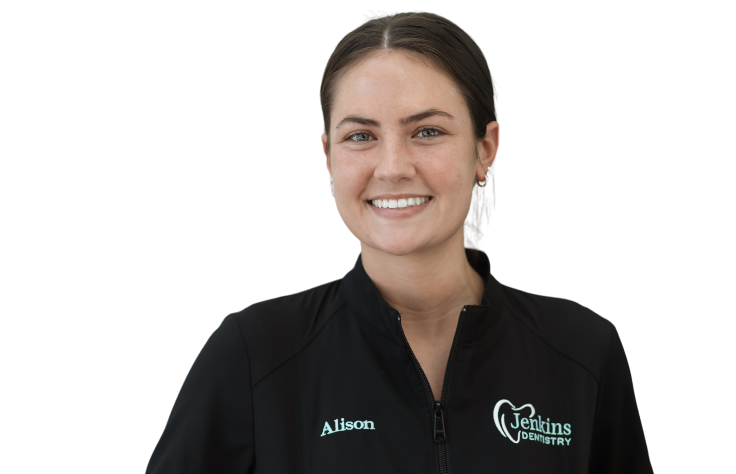 A woman wearing a black jacket over a green shirt stands confidently, showcasing a stylish and casual look.