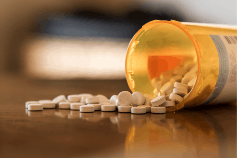 a bottle of medicine poured over